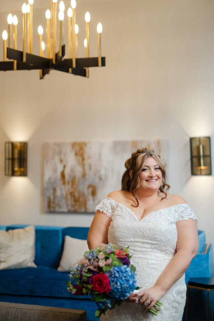 A bride smiles for her photo at The Goodwin Hotel in Hartford CT before her Hartford City Hall elopement