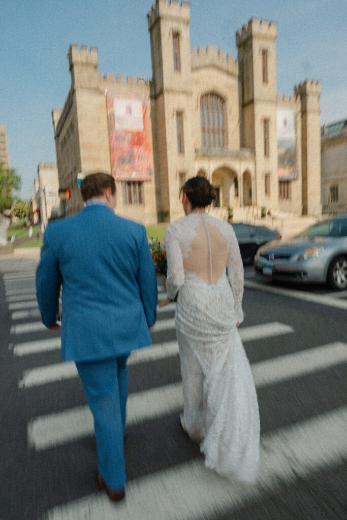 Two brides walk towards The Wadsworth Atheneum in Hartford before their Hartford City Hall elopement