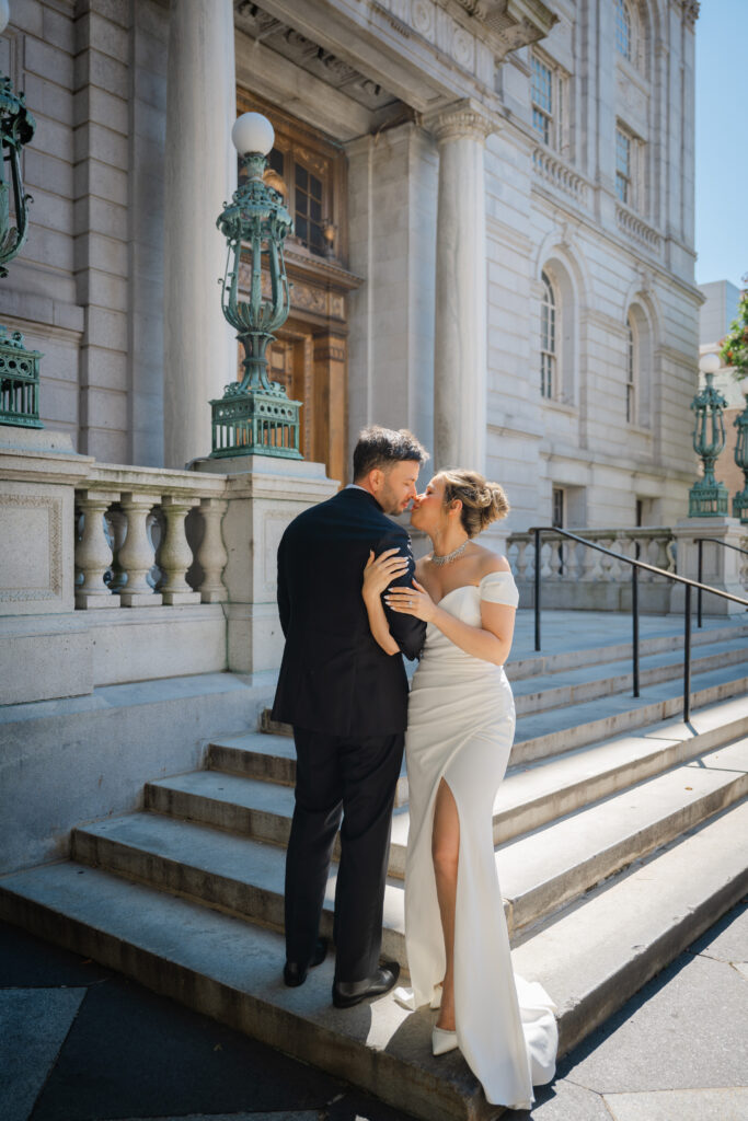 A couple kisses on the steps before their Hartford City Hall elopement