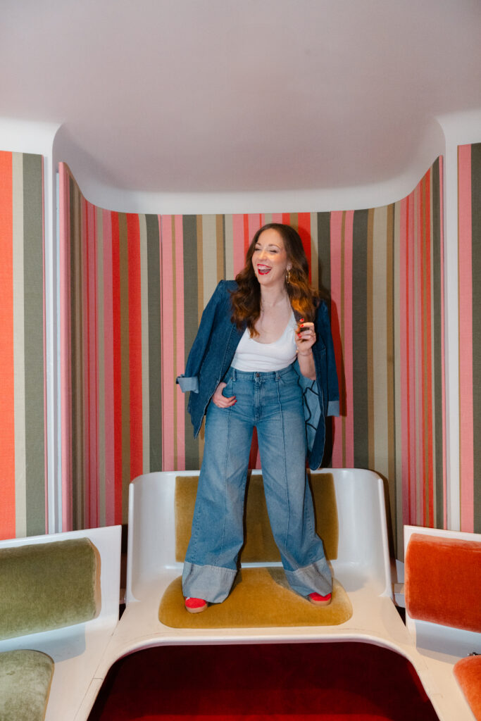 Carla Giorgio a Marketing Consultant, laughs during her on location branding session in the TWA Hotel in NYC