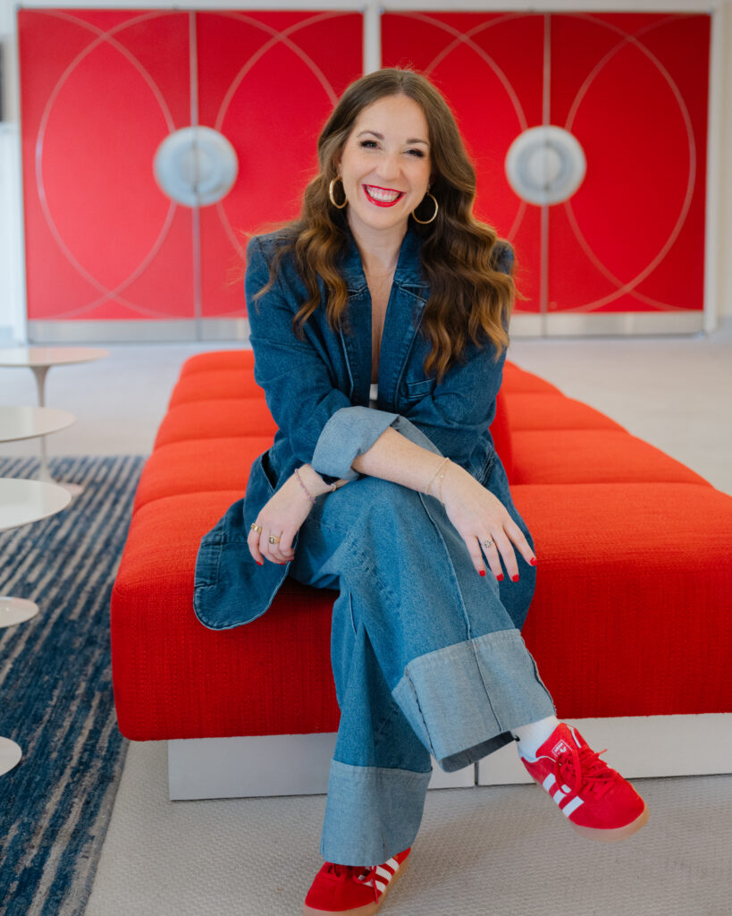Colorful red branding photos at the iconic TWA Hotel in NYC for a powerhouse marketing consultant, Carla Giorgio