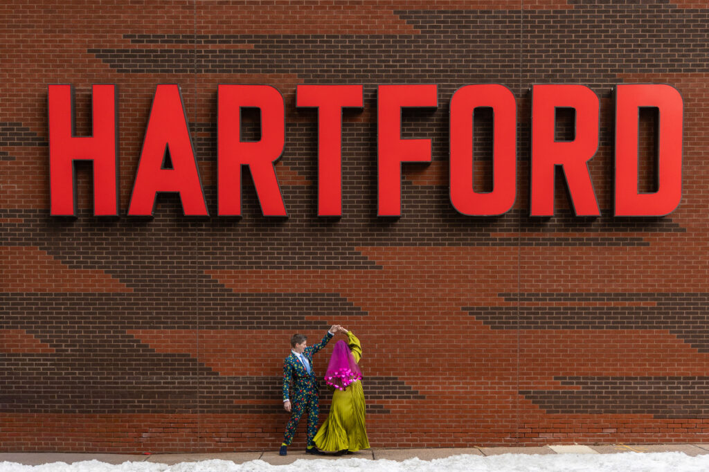 Two brides dance at The Hartford Stage before their colorful LGBTQ Hartford City Hall elopement