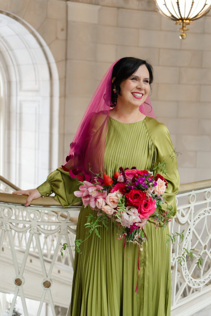 A queer bride in her chartreuse wedding dress and colorful bouquet during her Hartford City Hall elopement