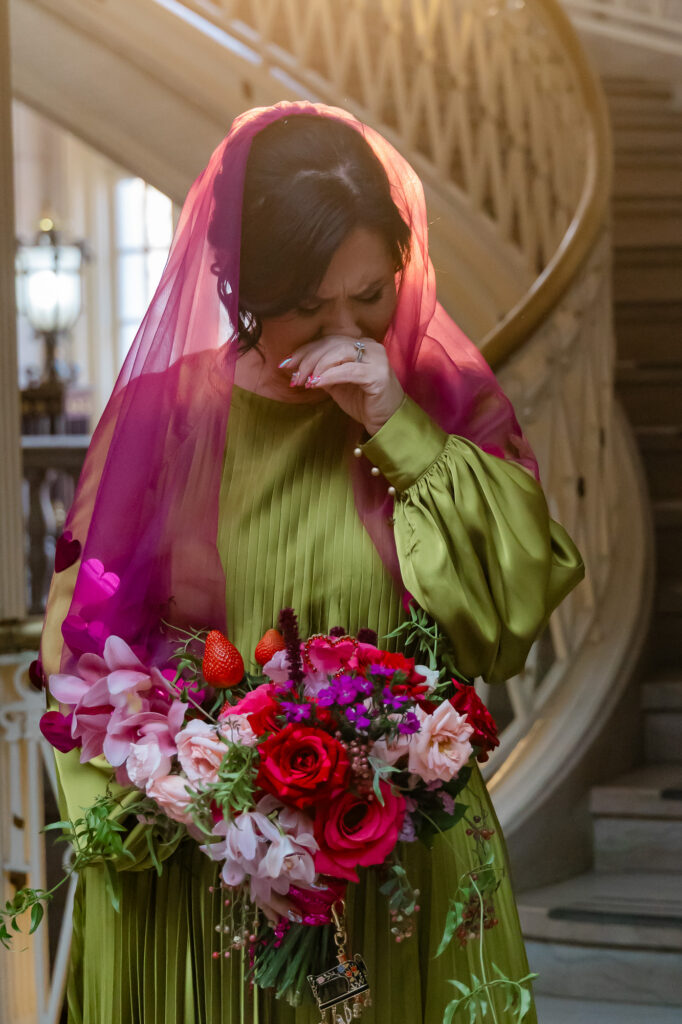 A bride gets emotional during her winter wedding portraits at Hartford city hall
