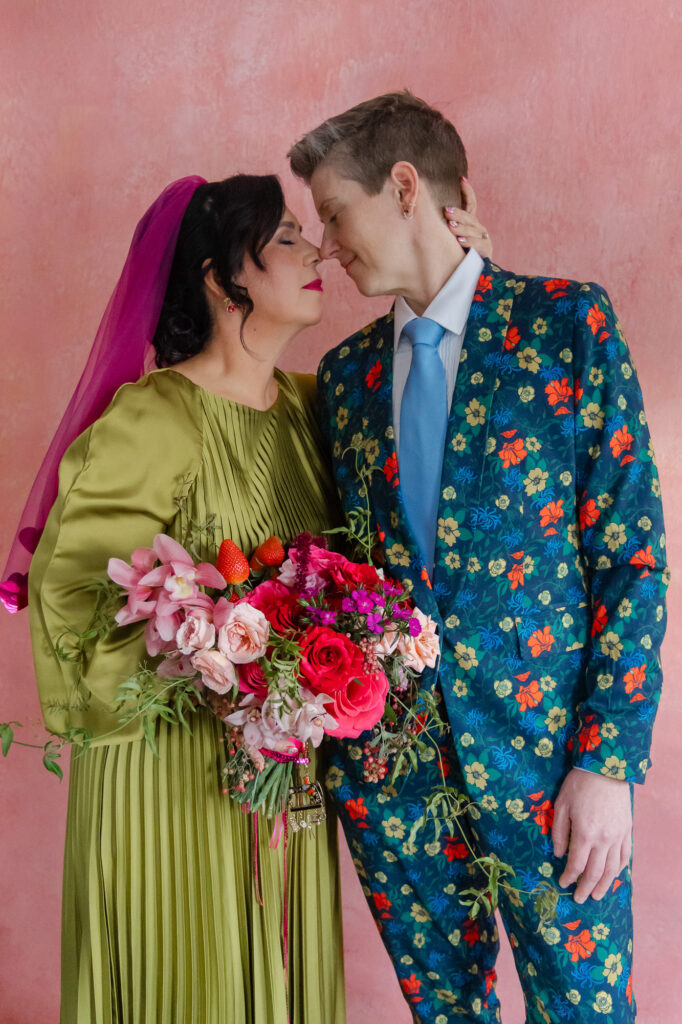 Two brides snuggle during their colorful Hartford City Hall elopement