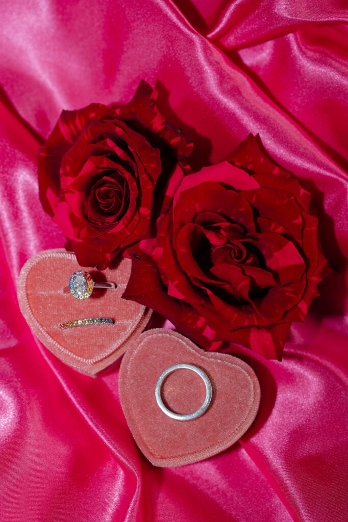 Colorful engagement and wedding bands from Shane & co. with red and pink roses for a hartford city hall elopement