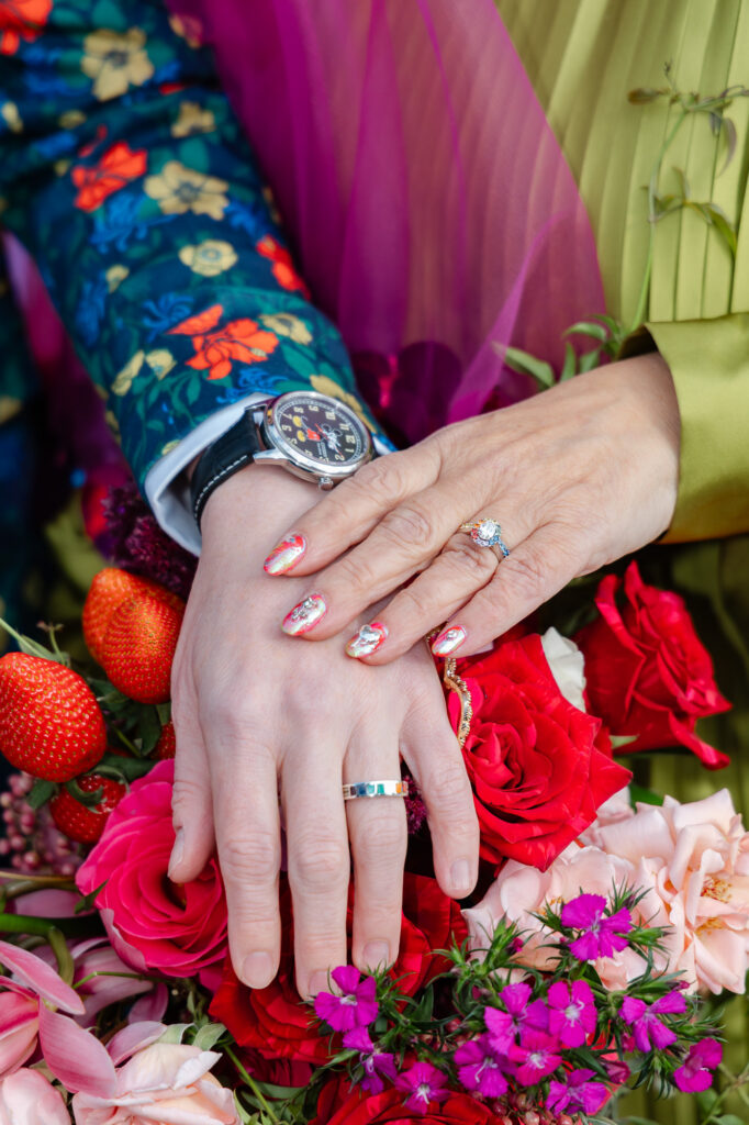 two brides show their colorful wedding rings during their colorful Hartford City Hall elopement in Hartford CT