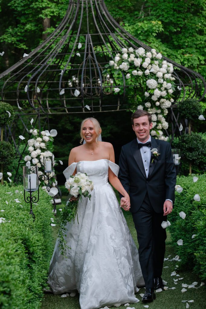 Lord Thompson Manor wedding photographer captures a jubilant bride and groom celebrate as they walk down the aisle after their outdoor wedding ceremony at Lord Thompson Manor in Thompson CT