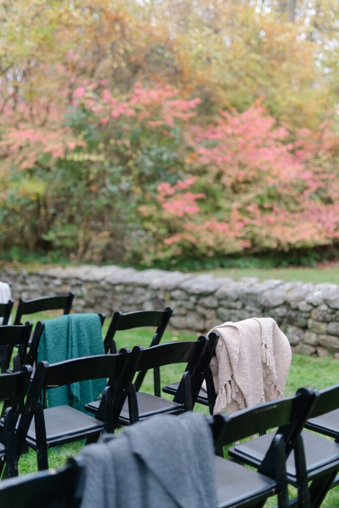warm blankets are laid out for an outdoor autumn wedding ceremony at Lord Thompson Manor in Thompson CT